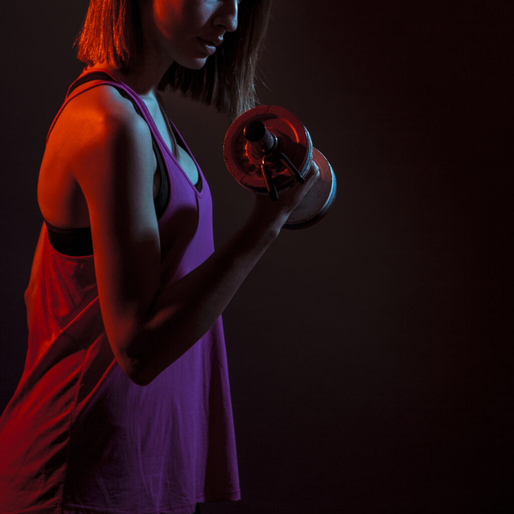 crop-athletic-woman-training-bicep-dark