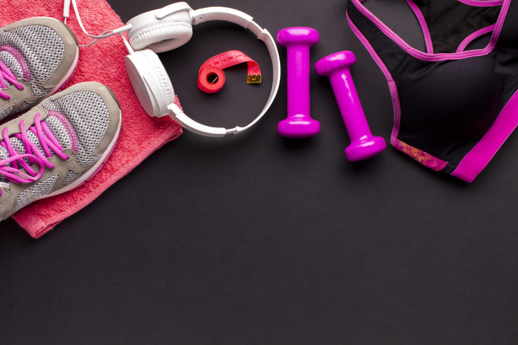 top-view-frame-with-pink-items-white-headphones